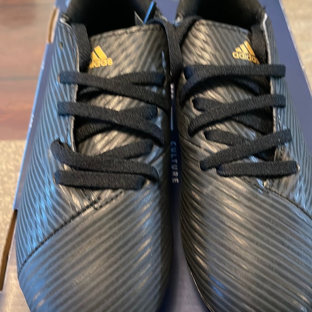 Used black soccer cleats for kids size 1 .